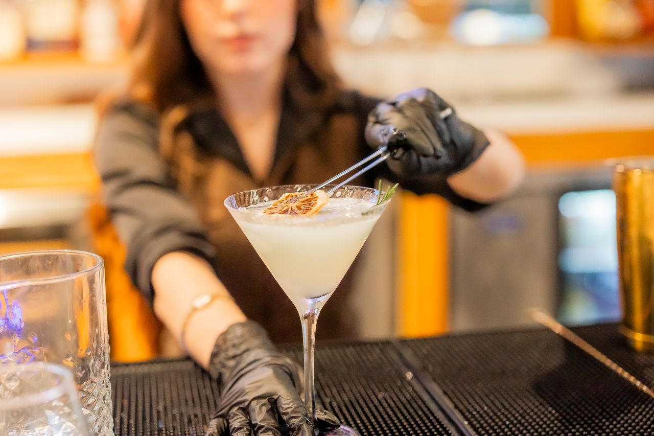 Bartender garnishing a martini at The Boardroom Lafayette