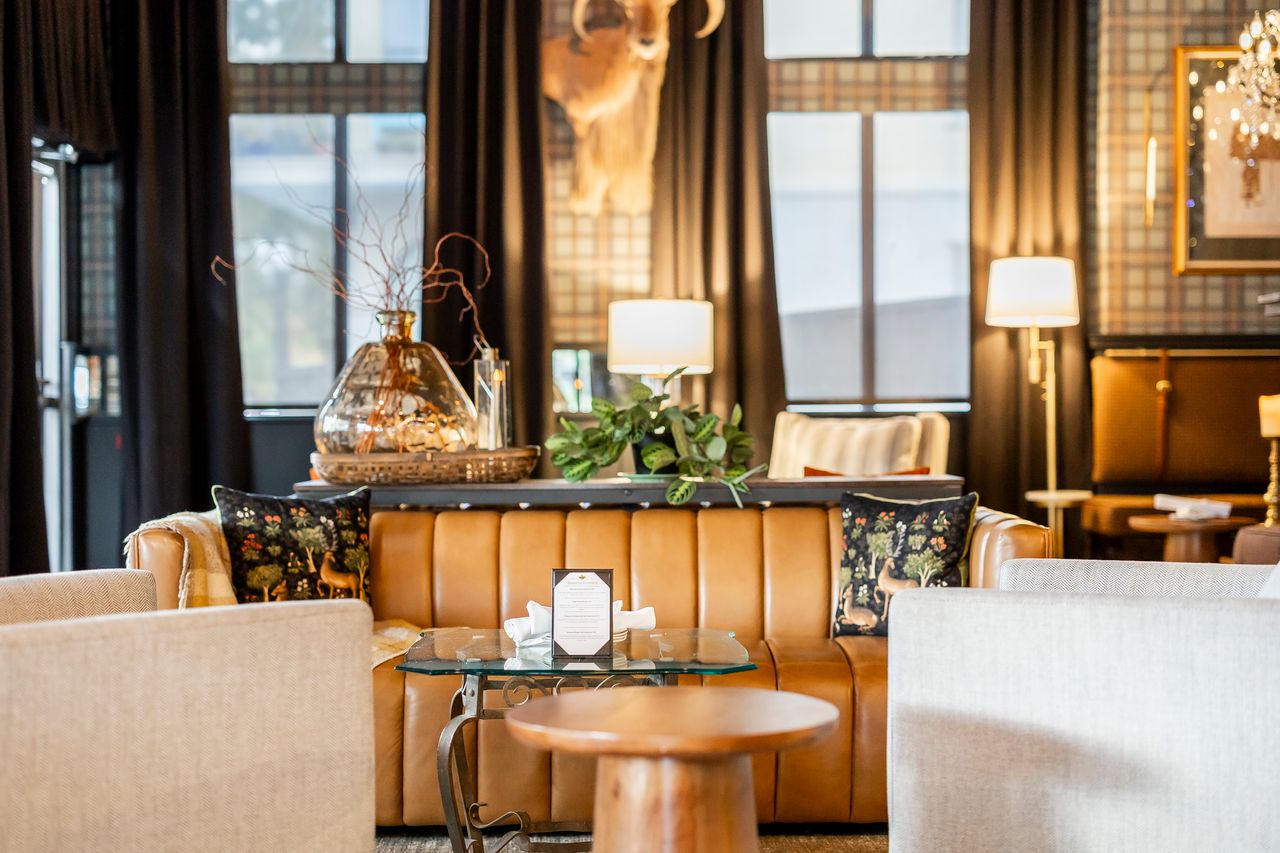 Tan leather channel sofa and lounge seating at The Boardroom