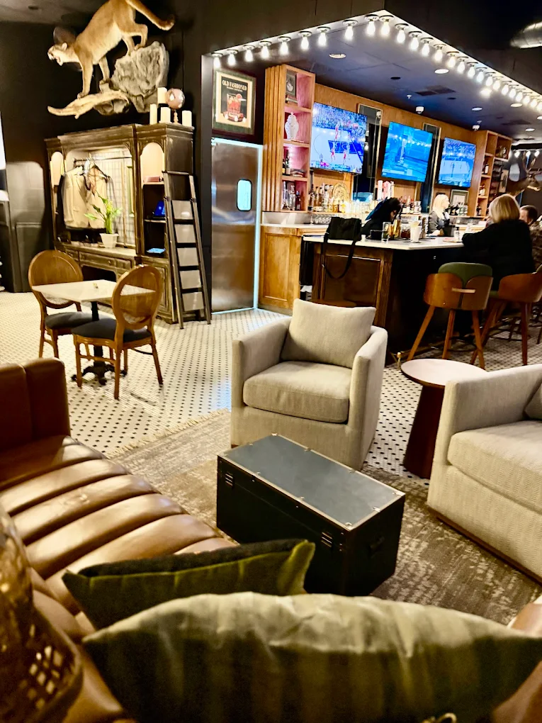 Lounge seating and bar with taxidermy at The Boardroom River Ranch